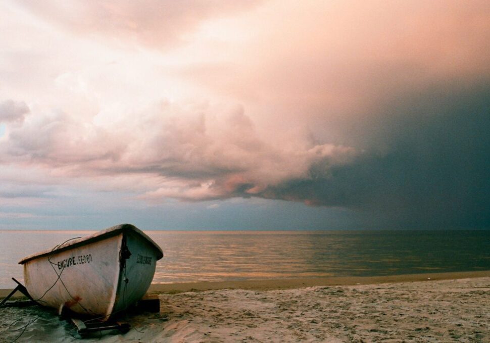 An empty boat on a stranded shore